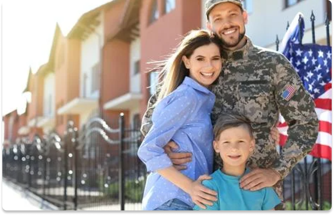 Military family in front of home